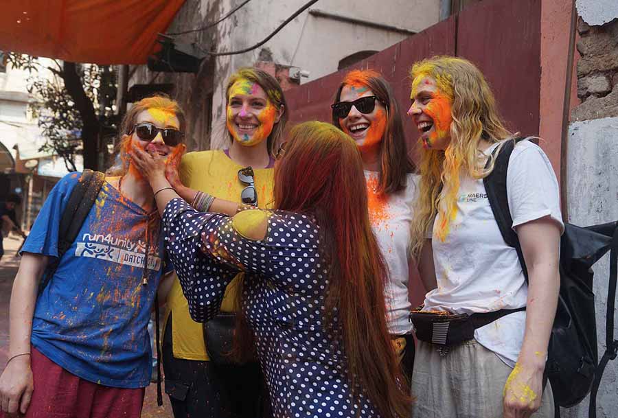 A group of foreigners enjoy the festival of colours as they play with ‘aabir’ on Sudder Street 