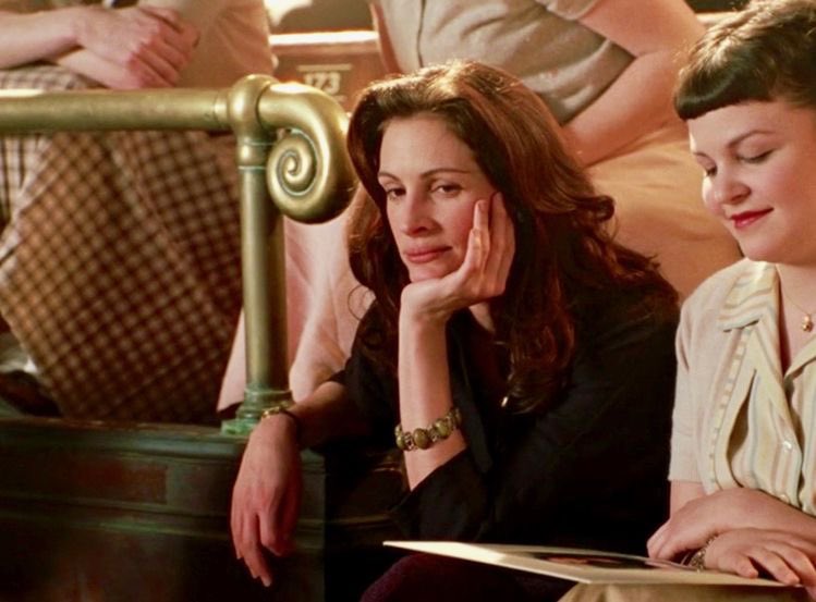 Mike Newell directorial, Mona Lisa Smile (2003), is a period drama, where a free spirited arts teacher in an all girls private school encourages the students to question the norms set by society for women and pursue their dreams.