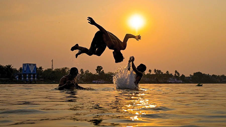 As temperature surges, young boys take a refreshing dive into the Hooghly river in Nadia on Thursday