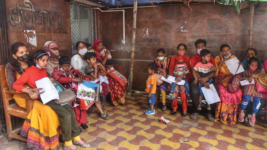 Parents and young kids wearing masks wait outside B.C. Roy Hospital, Kolkata, for medical consultation as the city continues to witness a rise in Adenovirus cases 