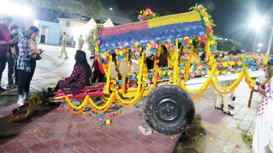 A pushcart decked up with flowers provides a photo opportunity. 