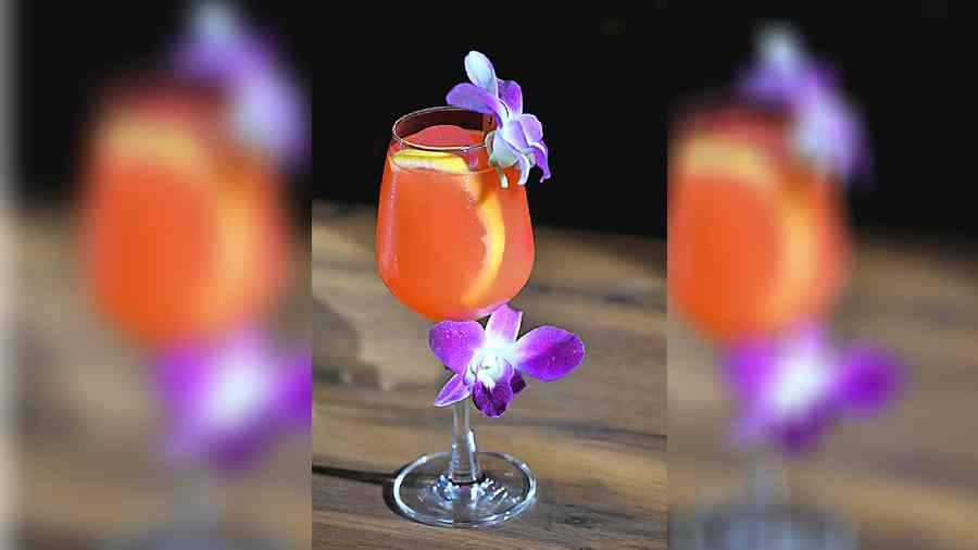 Summer Cooler is a vodka-based drink mixed with fresh grapefruit juice and tinned grapefruit syrup and garnished with pretty orchid flowers. Perfect to turn down the heat in summer.