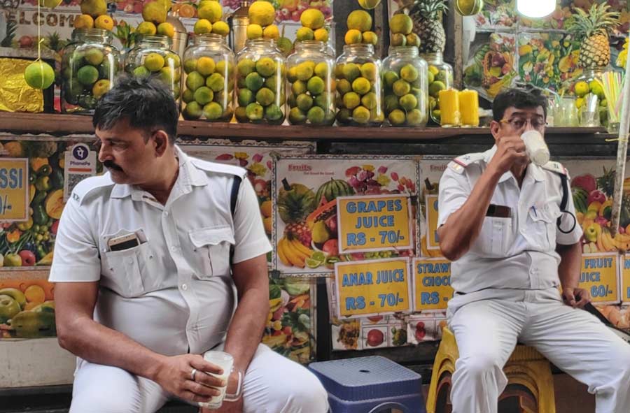 Two policemen take a much-needed lassi break in Kolkata on Friday. The day remained cloudy though the mercury touched 33 degrees Celsius. The Met office has predicted a sunny Saturday with a maximum temperature of 36 degrees Celsius 