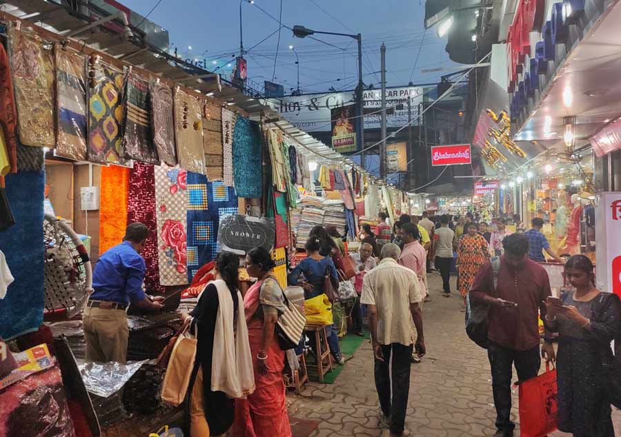 People bargain with shopkeepers at Gariahat market on Friday   