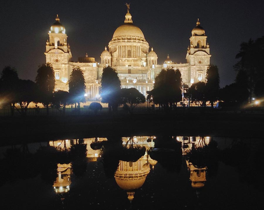 The mesmerising reflection of an illuminated Victoria Memorial Hall on the water body in the premises on Saturday evening  