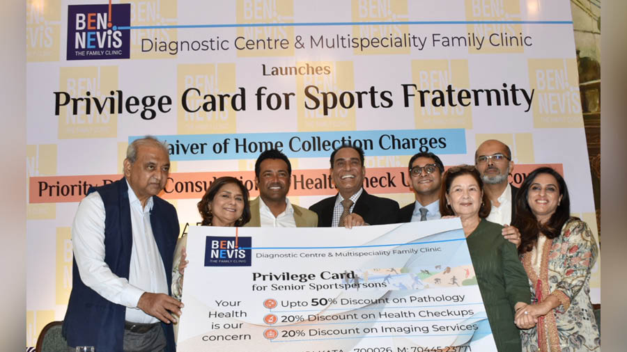 Former hockey player Vece Paes receives the Bennevis privilege cards for senior citizens from the sports fraternity on Sunday in the presence of son and tennis champion Leander Paes and doctor Pronab Dasgupta, among others  