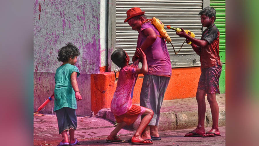 Children play Holi on Muktaram Babu street in central Kolkata 