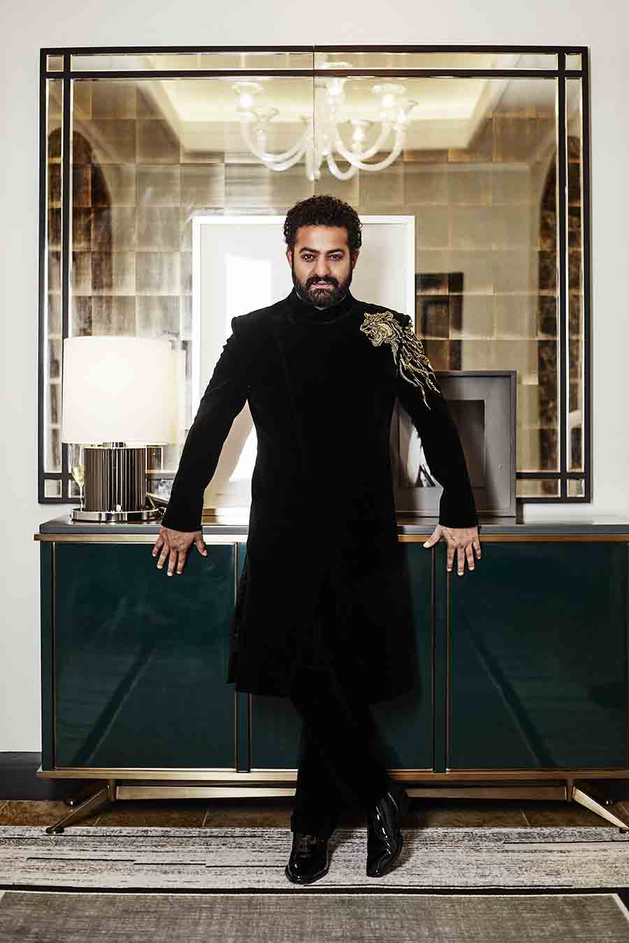 NTR Jr turned up the heat in an all-black sherwani suit with a tiger motif embellishment on the shoulder. 
