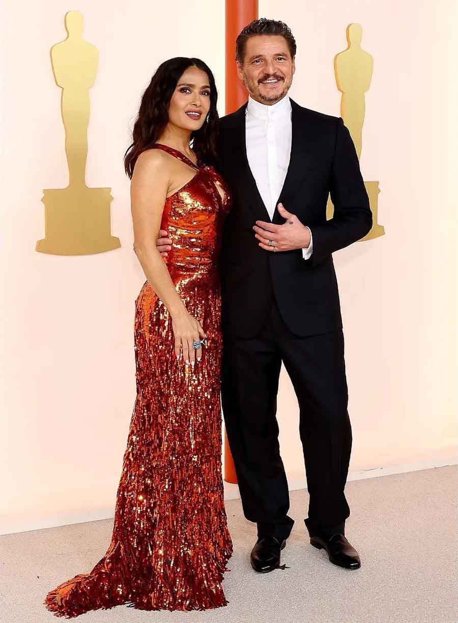 Salma Hayek stunned in a burnt-orange sequin Gucci gown, while Pedro Pascal went for a classic black tux without a bowtie.