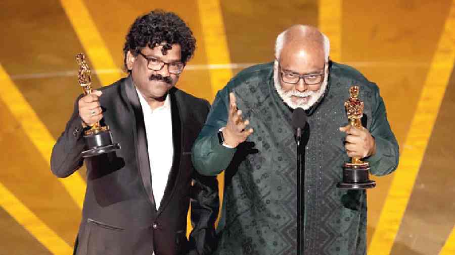 Composer M.M. Keeravani (right) and lyricist Chandrabose accept the Oscar for Best Original Song for Naatu naatu from RRR