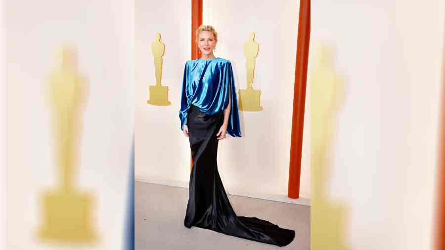 Cate Blanchett, known for recycling her outfits on the red carpet (because why not!), opted for an eco-friendly and sustainable outfit from Louis Vuitton. The satin outfit had two shades of blue — sapphire and midnight blue — and featured a top with power shoulders and a skirt. With her hair in a neat bun, minimal makeup and a pair of drop diamond earrings, Cate stunned everyone with her poise.