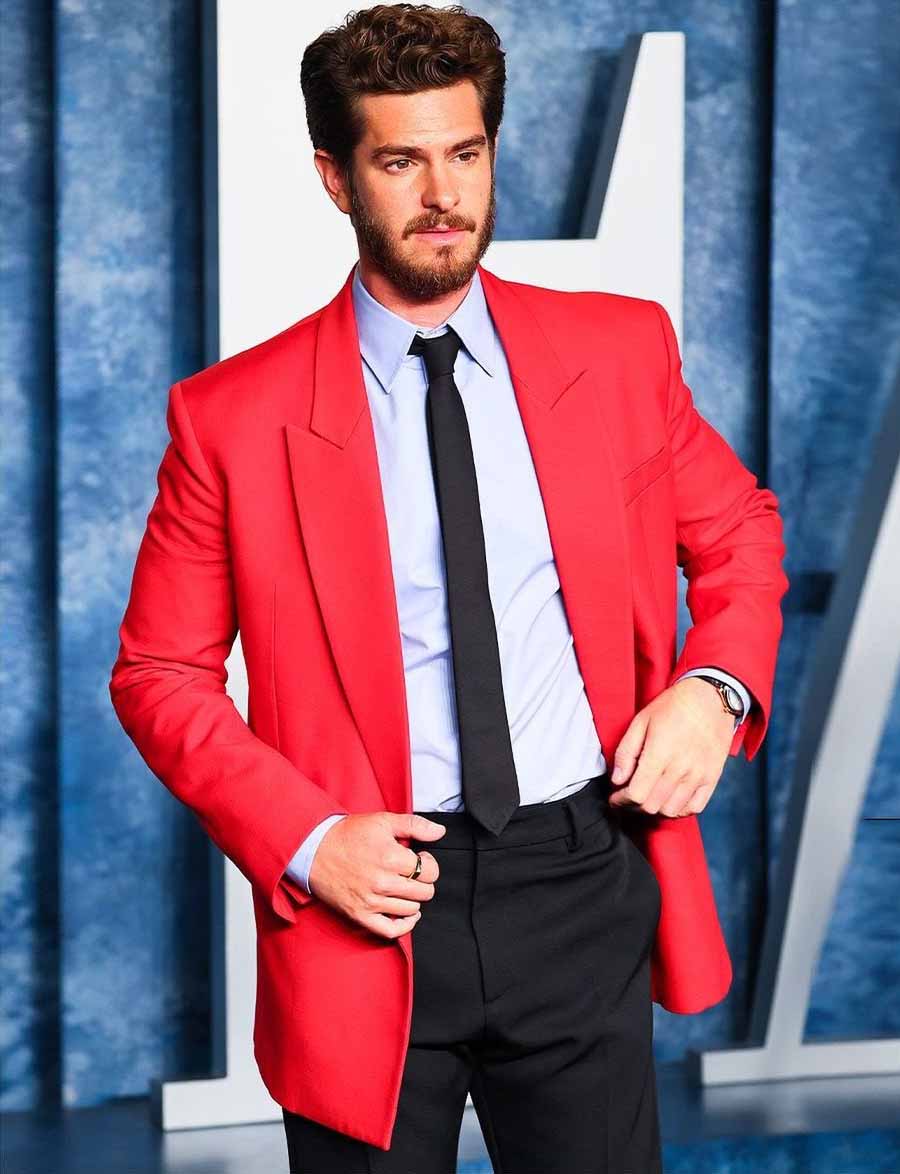 Andrew Garfield added a pop of colour with a Maison Valentino outfit — a red fitted blazer paired with a light blue shirt, black trousers and a sleek tie. 