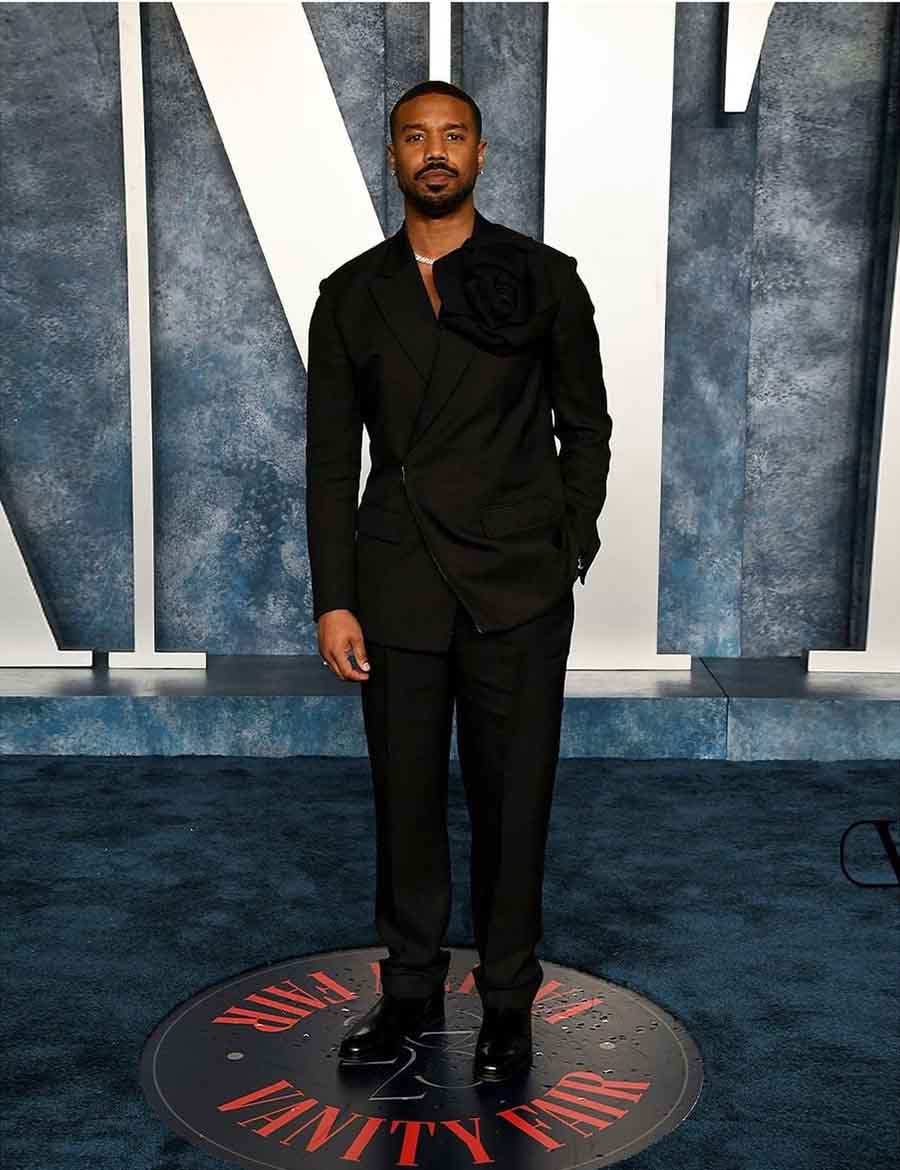 Michael B. Jordan showed up in a full Maison Valentino look — a rose-adorned black viscose jacket with matching trousers and a sleek necklace. 