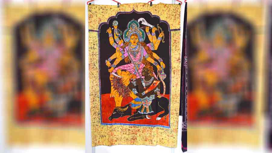 This exquisitely-designed creation on batik with a life-sized motif of goddess Durga slaying Mahishasura can be used as a tapestry. It is the biggest crowdpuller at this stall showcasing fabric-painted clothing and other hand-painted art objects.