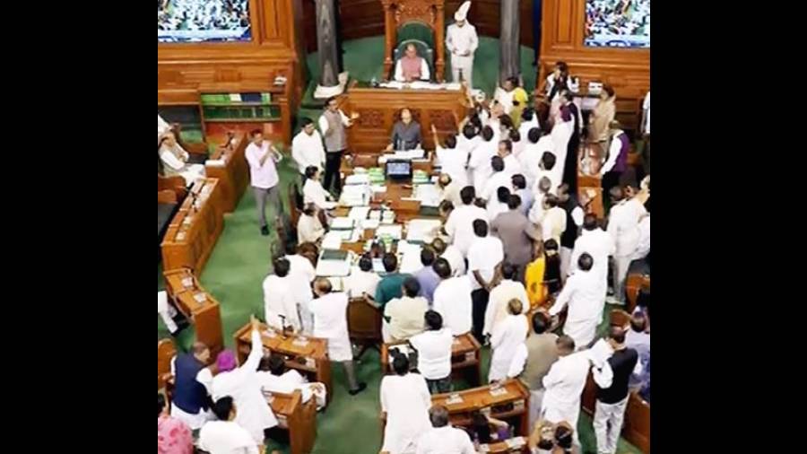 Opposition members protest in the Well of the Lok Sabha on Friday.