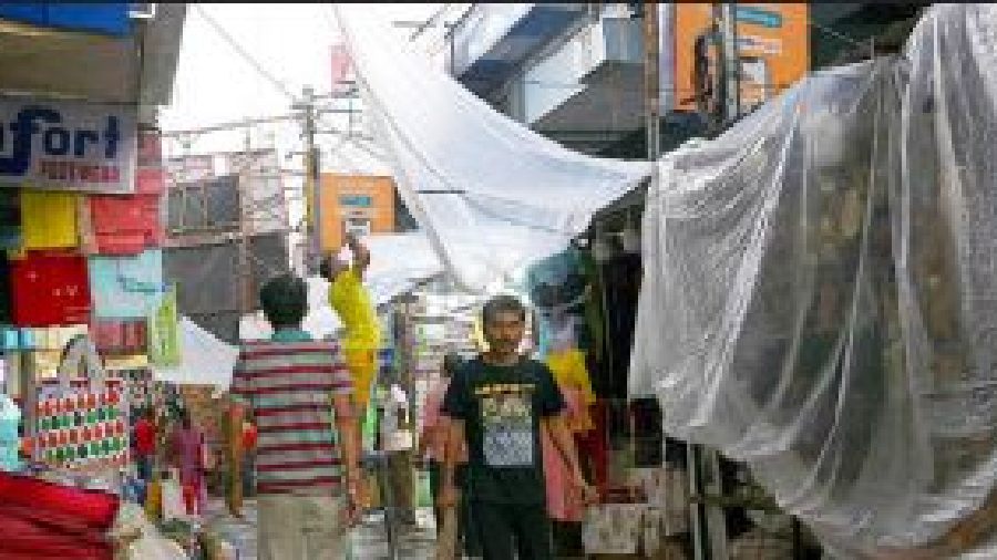 Plastic sheets over hawkers’ stalls in Gariahat on Sunday