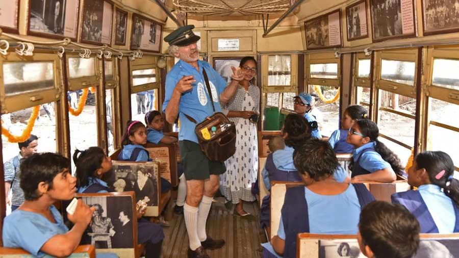 Roberto D'Andrea, former Melbourne tram conductor and activist, entertains children on board a joy ride as part of Tramjatra 2023 