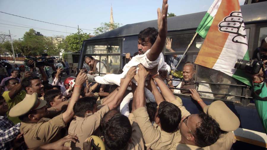 Police detain Congress party workers during a protest march againt the disqualification of the party leader Rahul Gandhi from Lok Sabha, in Lucknow. 