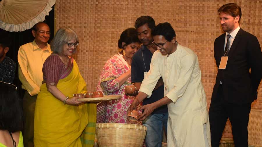 Skilled weavers and artisans participate in the rice pouring ceremony to  herald the beginning of the Nabanna Mela and the Nabanna Earth Weekend