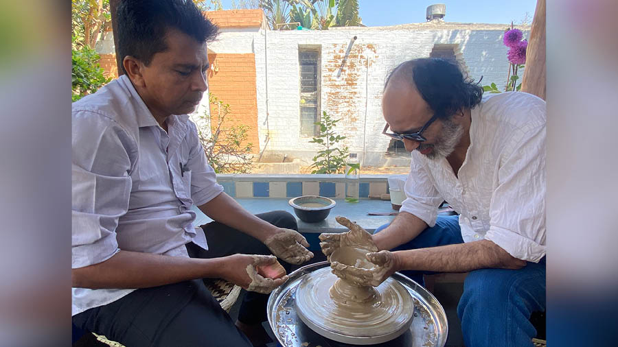 As a part of Nabanna, master craftsman Arun Pal (left) conducts a pottery workshop at Confetti, Daronda, Birbhum