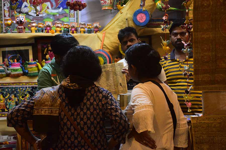 Visitors contemplate the handicrafts at the fair 