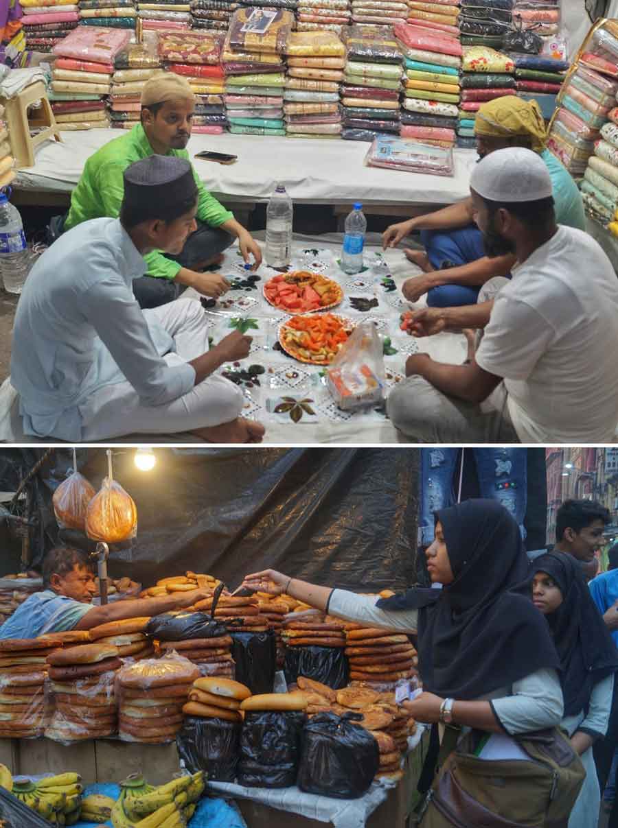 Shopkeepers near Nakhoda Masjid break their fast on Friday, the start of the Ramzan month  