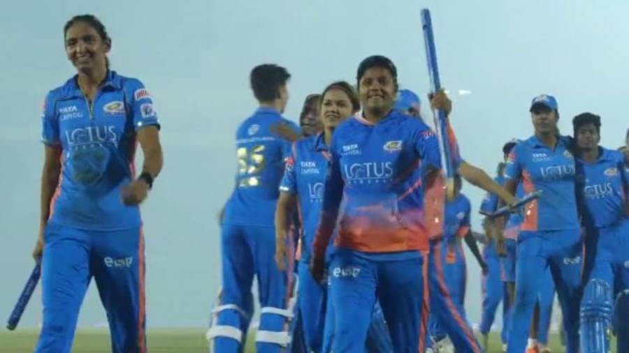 Harmanpreet Kaur leads her team off the ground after winning the final