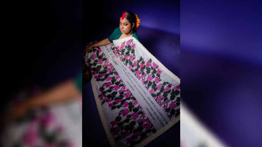The season of bougainvillaeas is here and the designer uses the canvas of a sari to embrace that. The use of shayari running through the pink bougainvillaeas makes it poetic.  