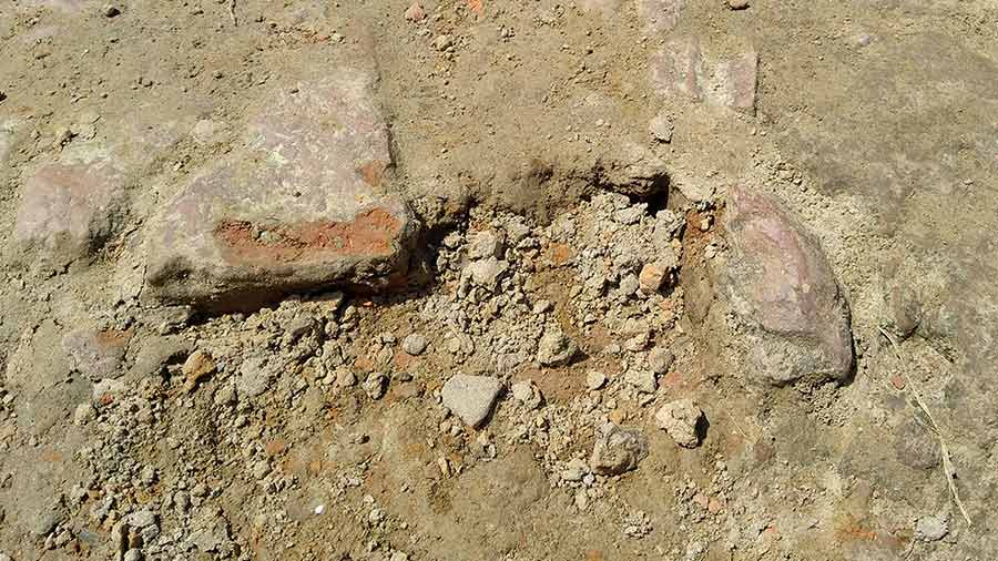 Terracotta structures visible on the ground at Dhosa archaeological site
