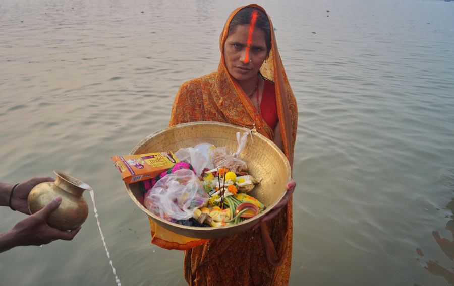 A devotee performs Chaiti Chhath at Ahiritola Ghat on on Monday