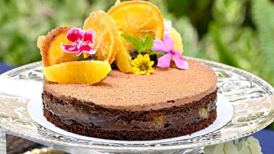 Chocolate Fresh Orange Crunch: Fresh orange segments, candied oranges and their signature flowers adorn this chocolate cake! A balance of tart and rich flavours.