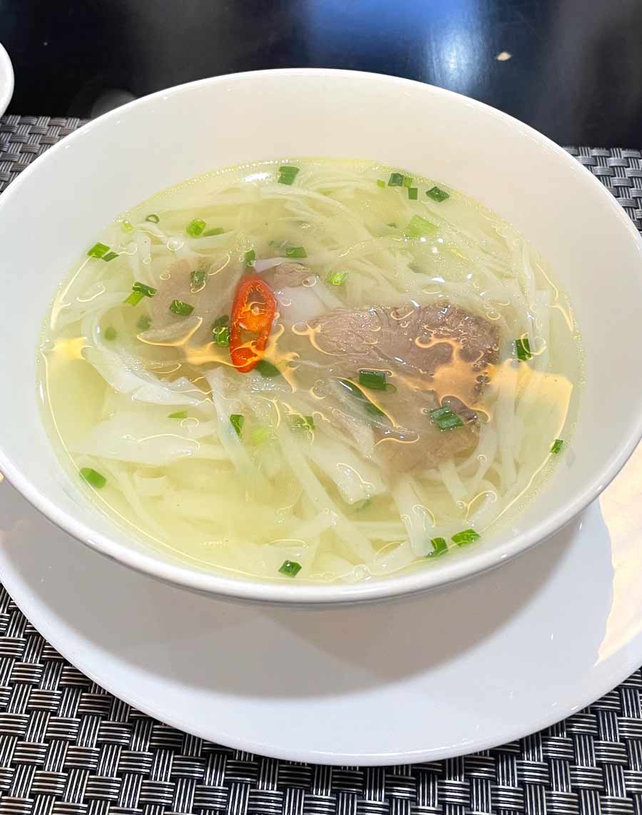 A steaming bowl of Pho: Pronounced ‘phuh’, this noodle soup is Vietnam’s national dish and for good reason too! Cooked in a beef-bone broth with a hint of star anise, the soup is unusually light and aromatic. The clear broth is served with chewy boiled rice noodles and thinly sliced beef. The broth is undoubtedly the hero of the show, warming you up with every sip. Add fresh herbs to the mix along with some of the spicy red chillies and soya sauce, and your hunger pangs and taste buds will surely be satisfied