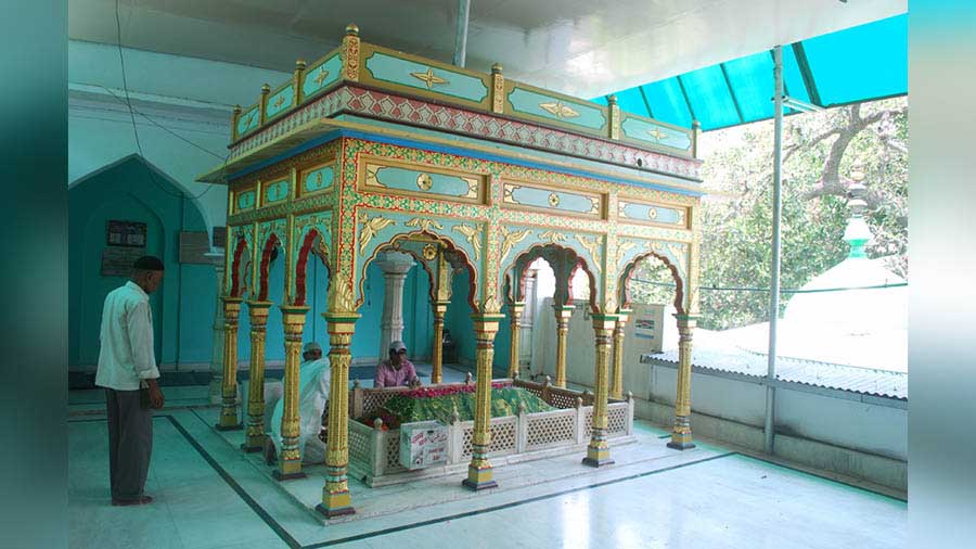 Another grave topped with a colourful ornate pavilion 