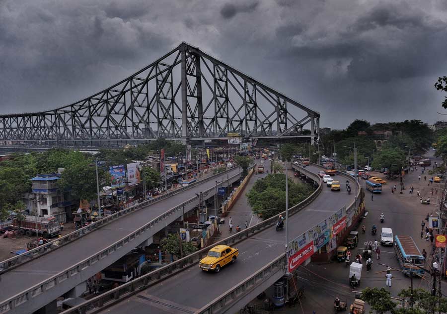 Clouds hover over the Howrah bridge on Monday afternoon. The India Meteorological Department (IMD) has forecast cloudy skies with possibility of thunder and lightning in Kolkata 