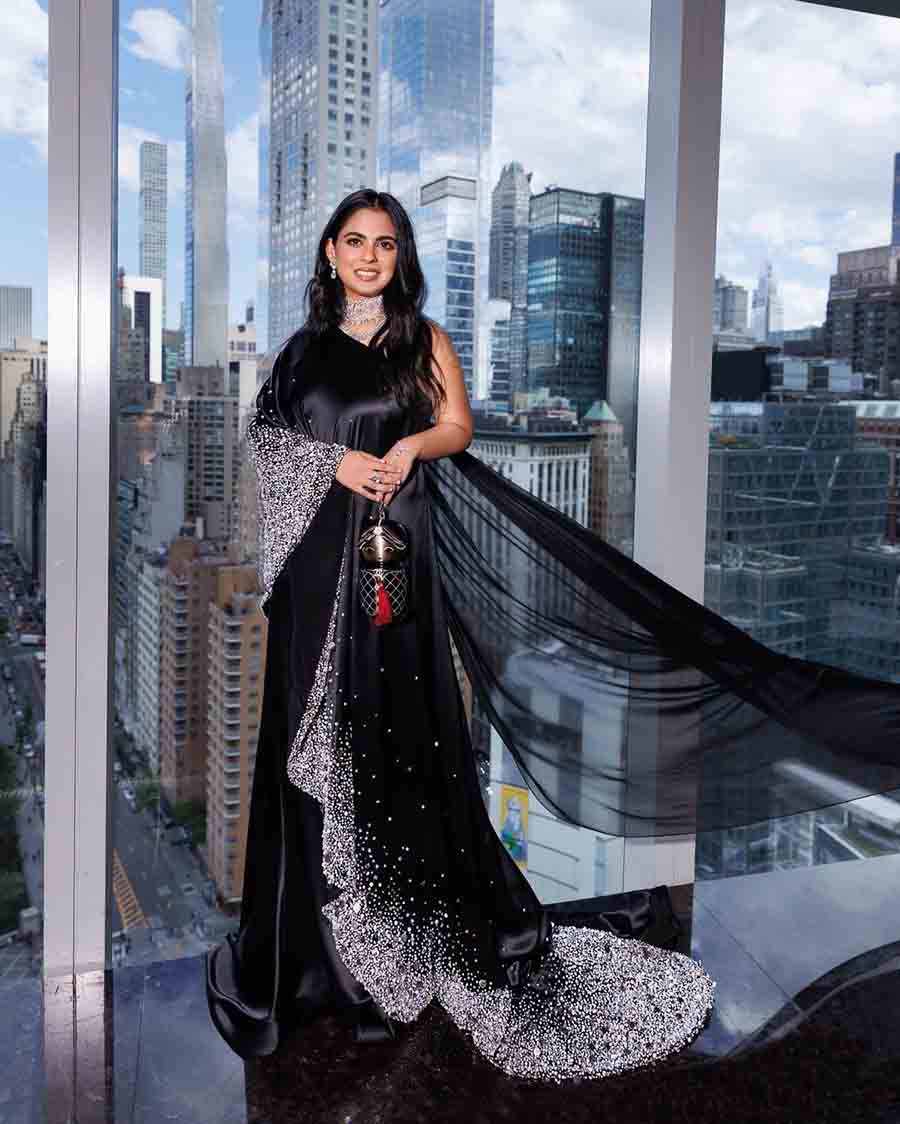 Isha Ambani looked stunning in a black satin sari gown by Prabal Gurung. The hand-embellished sari was paired with a Chanel bag and diamond jewellery.