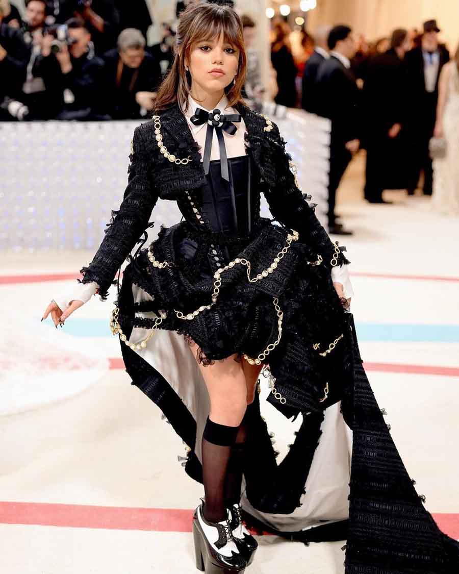 Wednesday star Jenna Ortega wore custom Thom Browne for the MET Gala. The outfit consisted of a cropped jacket, a black peau de soie corset dress and a black silk organza shirt.