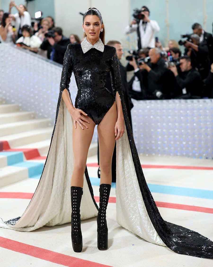Kendall Jenner wore a sequined black Marc Jacobs bodysuit with a matching cape sleeve attached to it. 