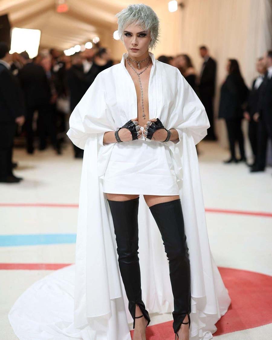 Cara Delevingne honoured Lagerfeld by recreating his silver-grey hair on the red carpet. The supermodel wore a custom low-neck white dress by the late fashion designer with fingerless black gloves and knee-high socks. 