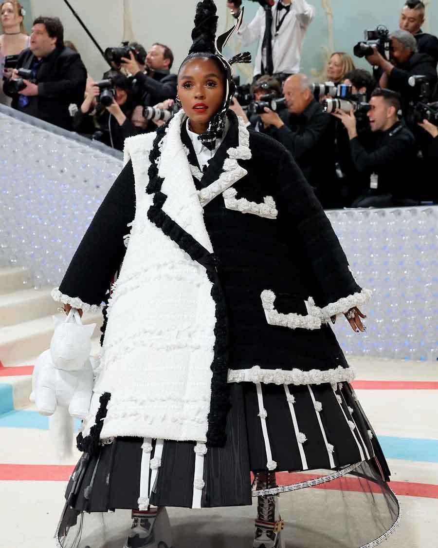 Janelle Monae wore a custom Thom Browne oversized coat in black and white with a circular tulle pannier dress. 