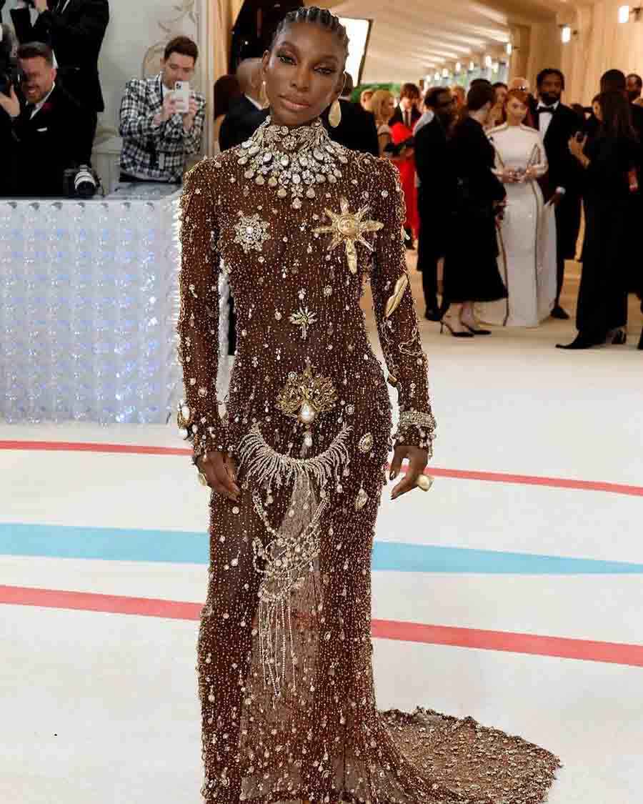 MET Gala co-chair Michaela Coel was decked up in custom Schiaparelli sheer dress with 1,35,000 golden embellishments. 