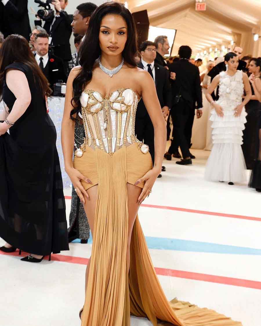 Yara Shahidi posed in a custom Jean Paul Gaultier nude gown with a structured corset top and layered bottom. 
