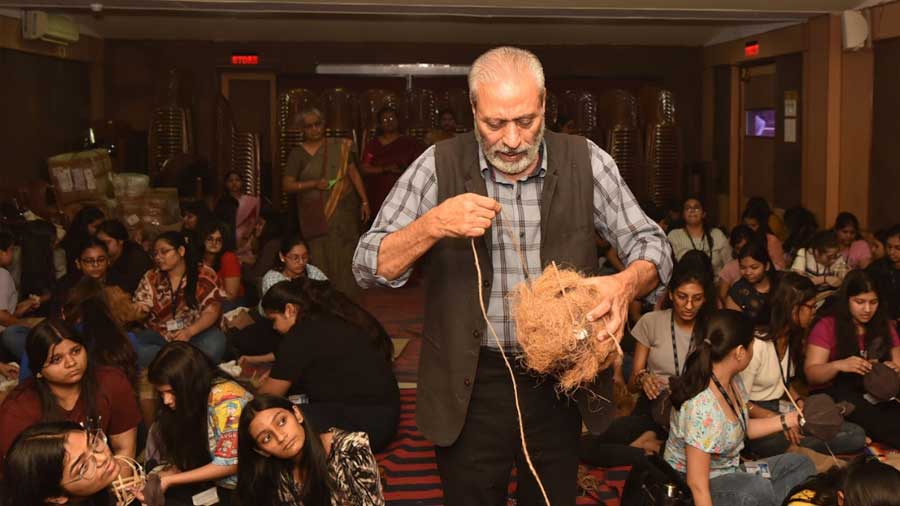 The conversationalist securing the nest with coconut fibre and string 