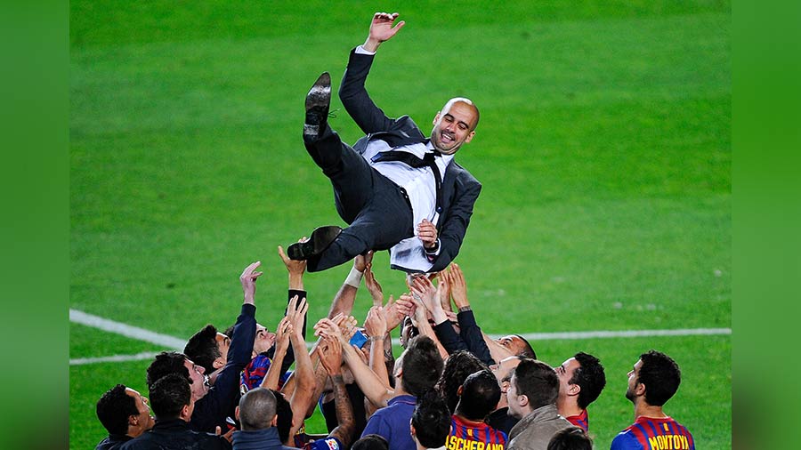 Pep hoisted by the Barcelona team at Camp Nou