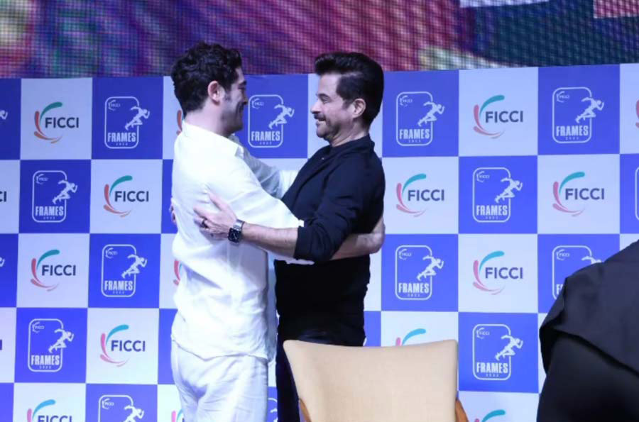Deniz shares a hug with Anil Kapoor at the FICCI FRAMES 2023 event in Mumbai. 
