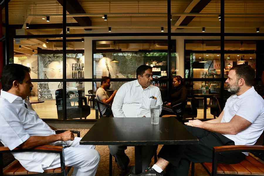 Congress leader Rahul Gandhi with party leader K.C. Venugopal at a Cafe Coffee Day outlet in Bangalore