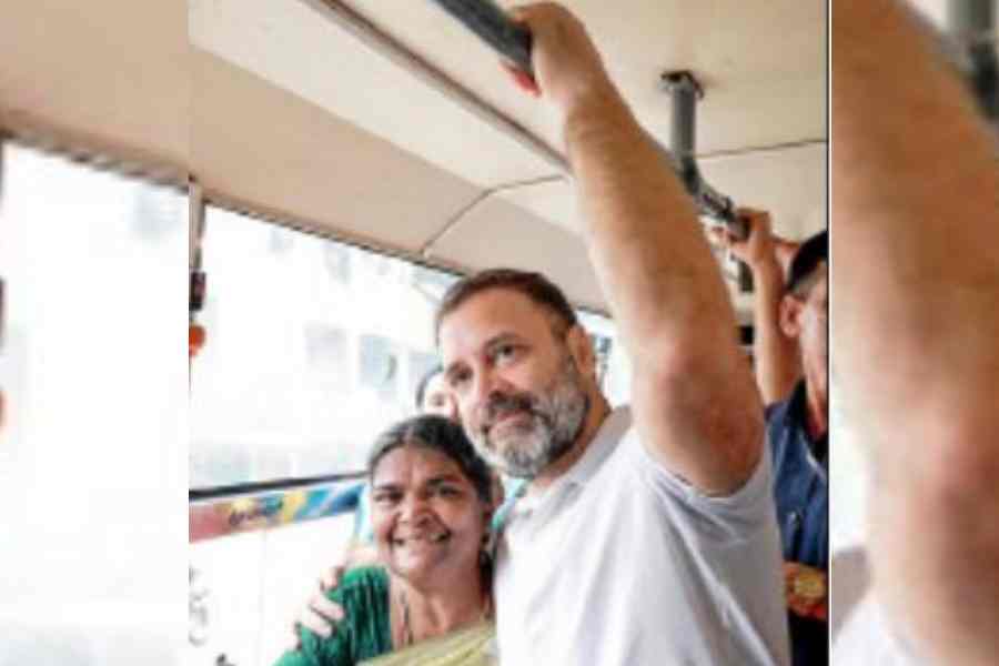 Rahul Gandhi poses for a picture with a passenger while riding a bus from Cunningham Road to Lingarajapuram in Bangalore on Monday. (Handout picture from the Congress)