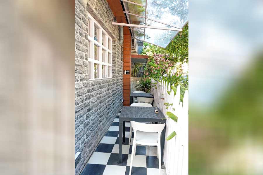 The alfresco area adds to the European charm of the place with the checkered floor and stone walls.