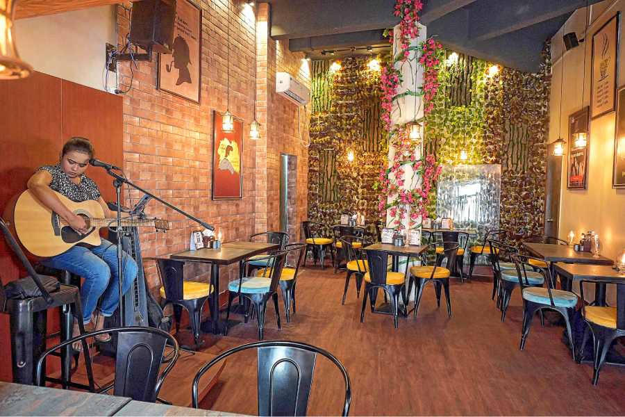 The interiors of the café are well-lit and spacious with different quirky detective posters hanging from the wall. The USP of the place is soulful live music adding to the vibe.