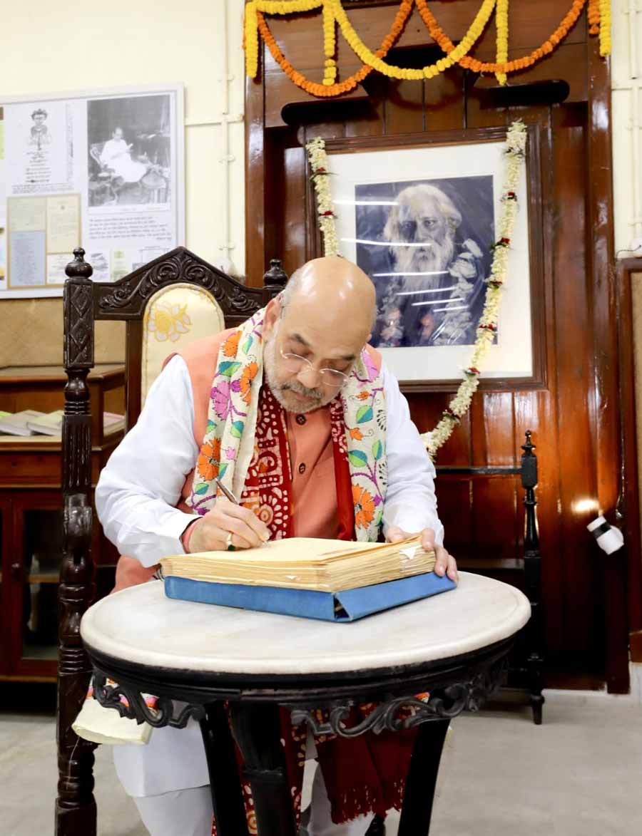 Union Home minister Amit Shah signs the visitors’ book during his visit to Jorasanko Thakurbari on Tuesday 
