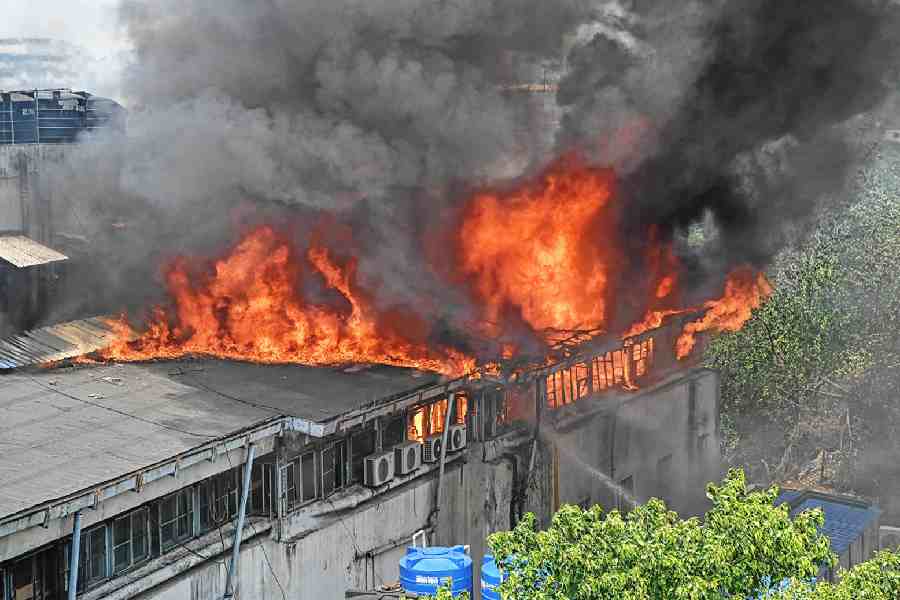 The fire rages on at Saraf Agencies, the four-storeyed commercial building close to Raj Bhavan, on Wednesday morning. 